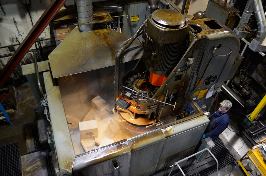 Overhead view of a Blanchard grinder in operation