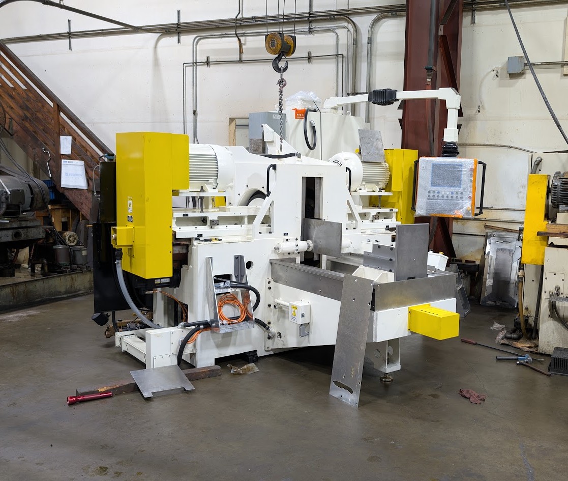 New white-and-yellow double disc grinding machine at Larkin Precision